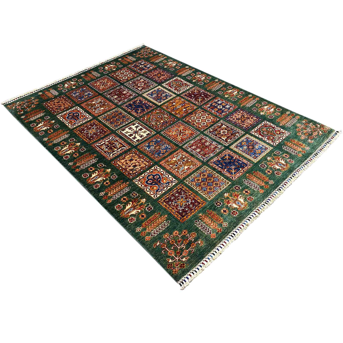 Hand-knotted green Khorjin rug, diagonal view with patchwork ornaments