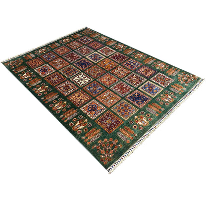 Hand-knotted green Khorjin rug, diagonal view with patchwork ornaments