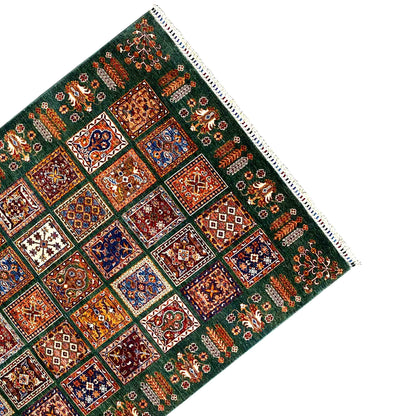 Hand-knotted Khorjin rug corner with fringes, green background and tile ornaments