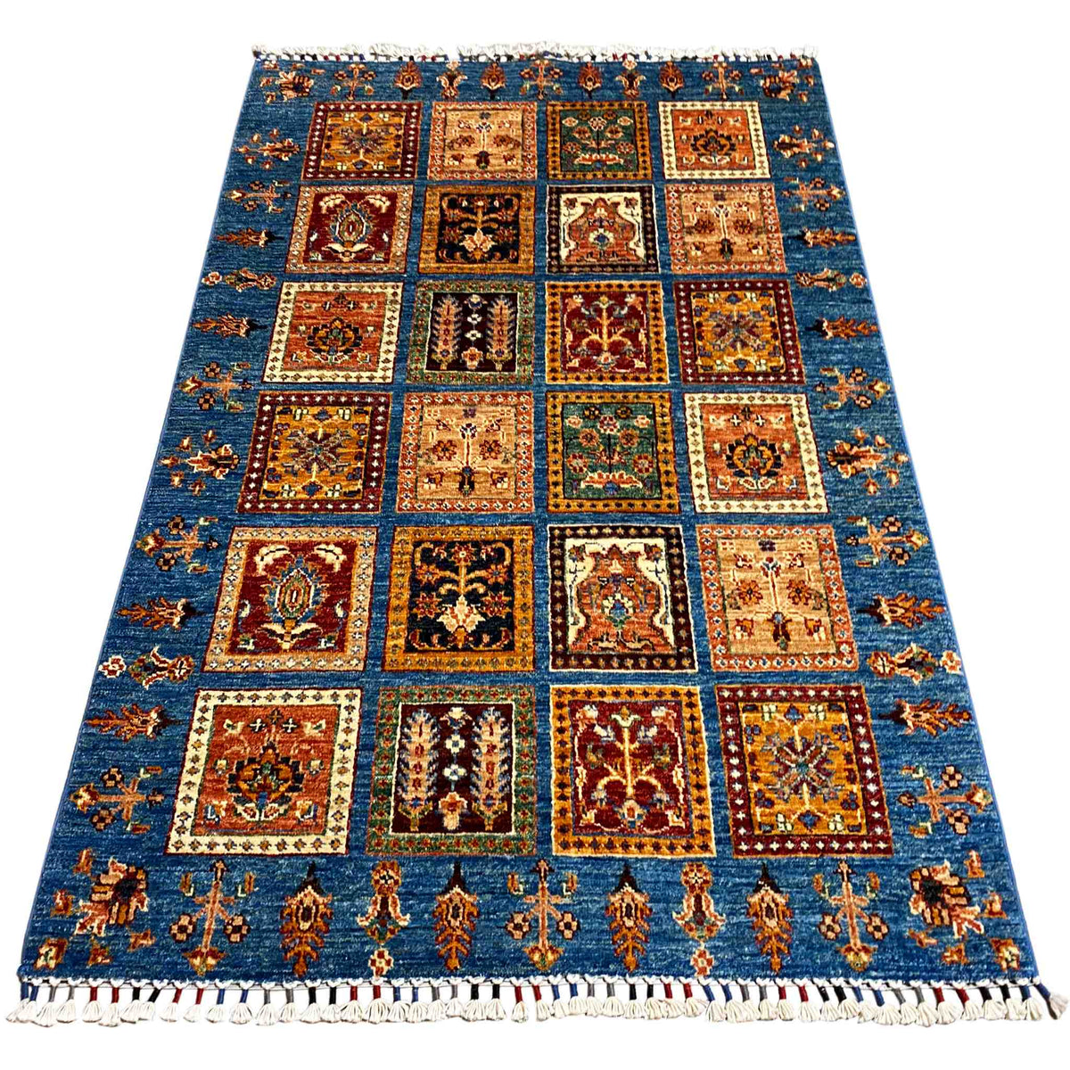 Khorjin rug, rectangular, blue field with colorful tile motifs and fringes along the edge