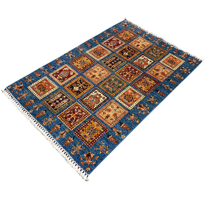 Rug with a blue background, a pattern of squares, and fringes at the corners