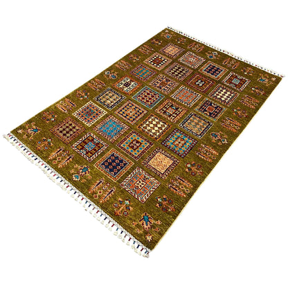 Khorjin rug in olive green with colorful square ornaments, fringed edge at the corner