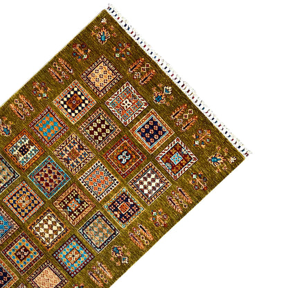 Khorjin rug in olive green with a corner, colorful ornamental panels, and a white fringed edge