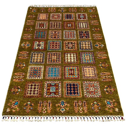 Olive-green rug with large patchwork squares and white fringes