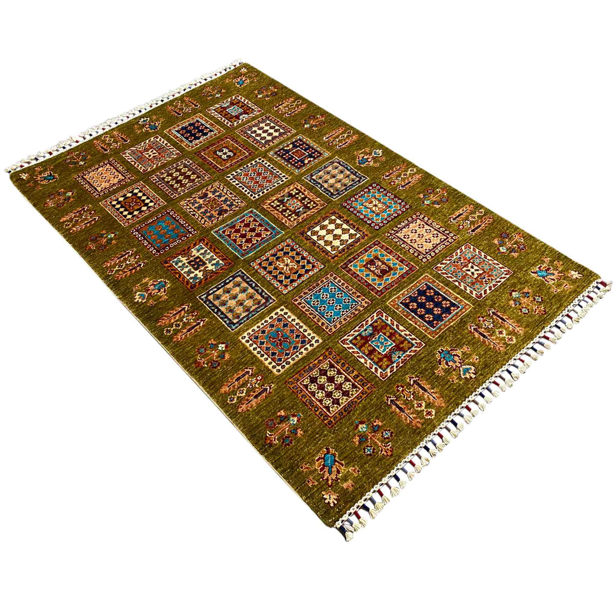 Olive green wool rug with patchwork motifs and white fringes