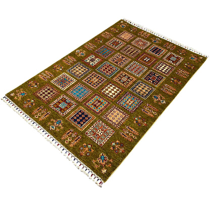 Olive green rug with a colorful square layout and white fringes