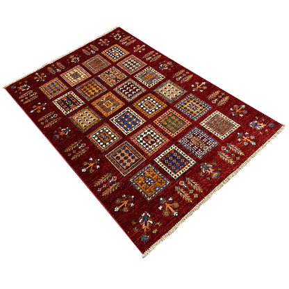 Afghan Khorjin wool rug, deep red, diagonal view with colorful square motifs.