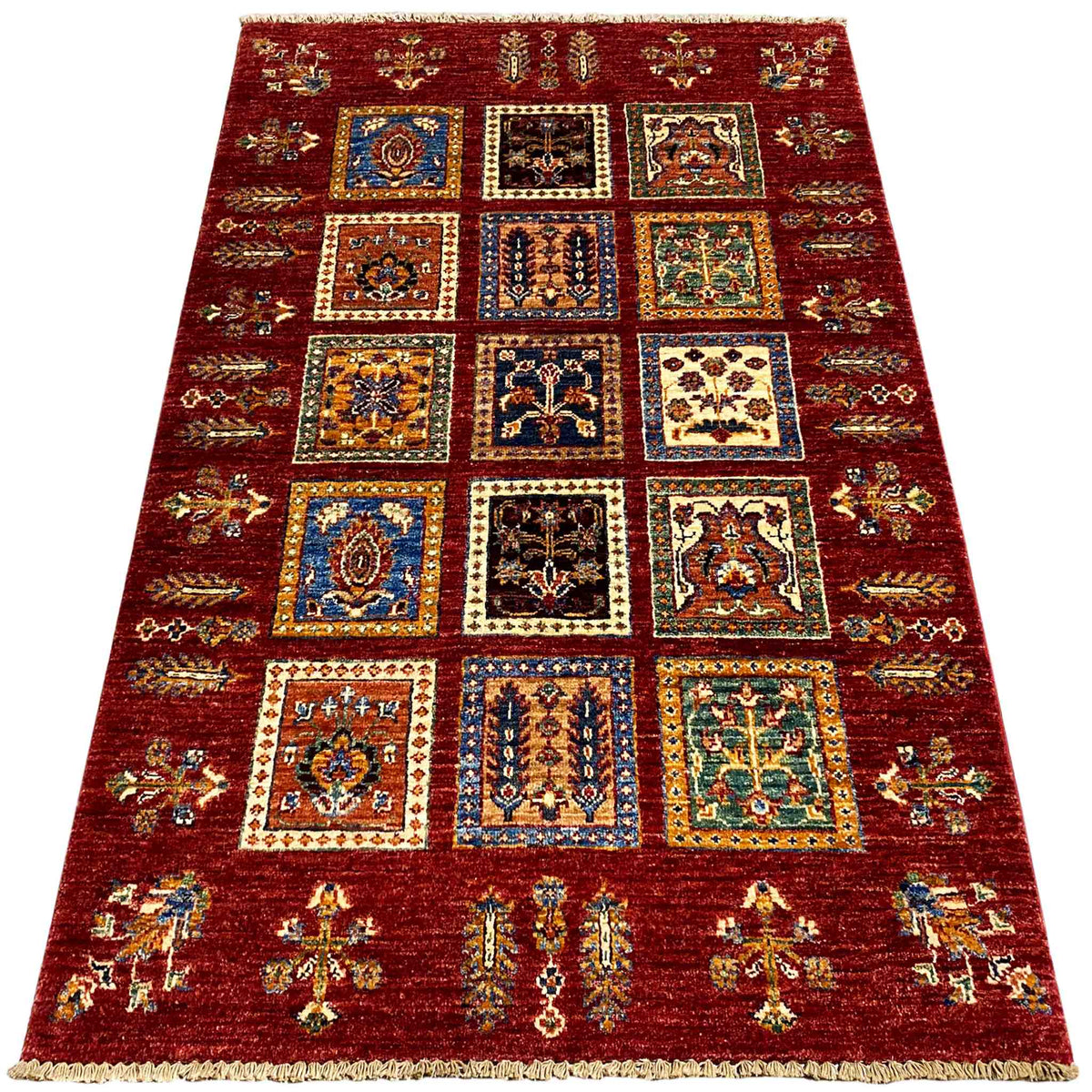 Deep red wool rug with square decorative panels and blue-and-gold ornaments, wide border