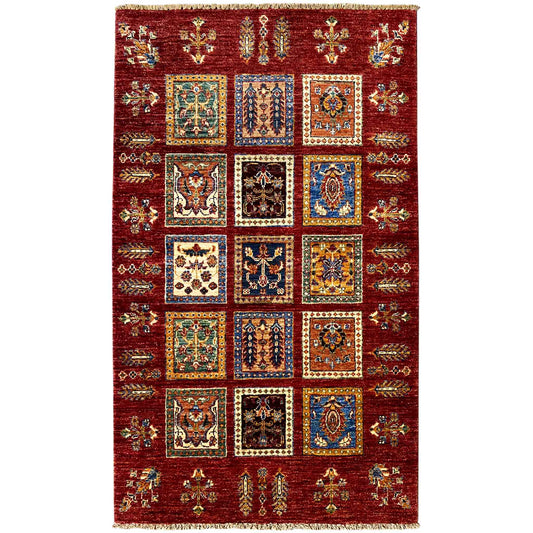 Deep red wool rug with Khorjin medallions and a geometric border with an all-over pattern