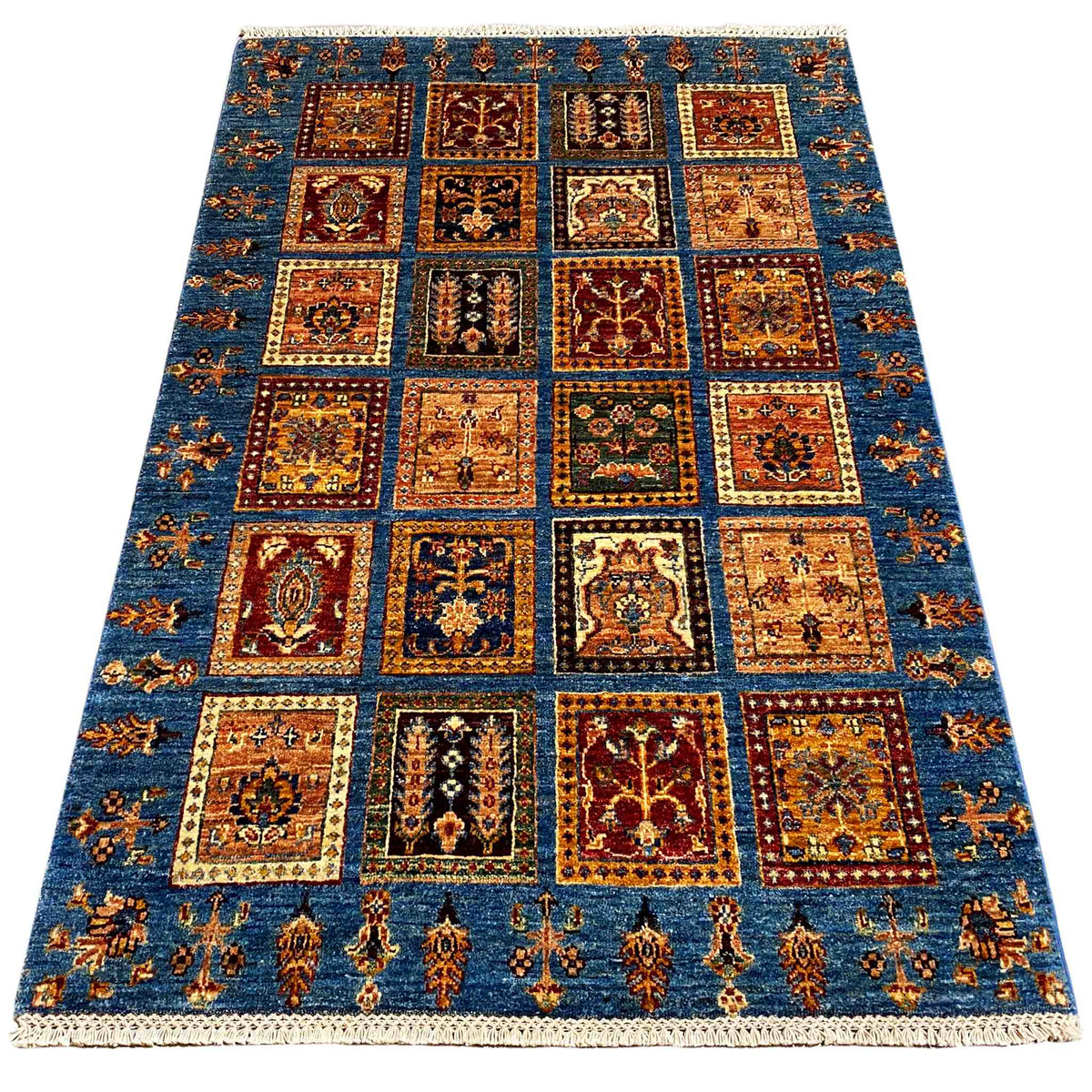 Blue wool rug with patchwork squares, geometric ornaments, and a wide border, 168x106 cm