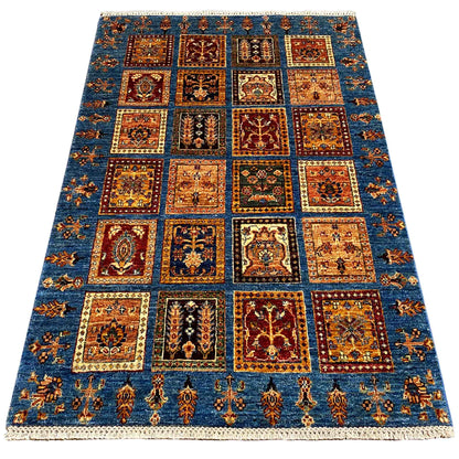 Blue wool rug with patchwork squares, geometric ornaments, and a wide border, 168x106 cm