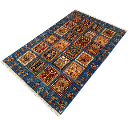 Detailed blue Khorjin rug with patchwork panels, ornaments, and fringes along the edge