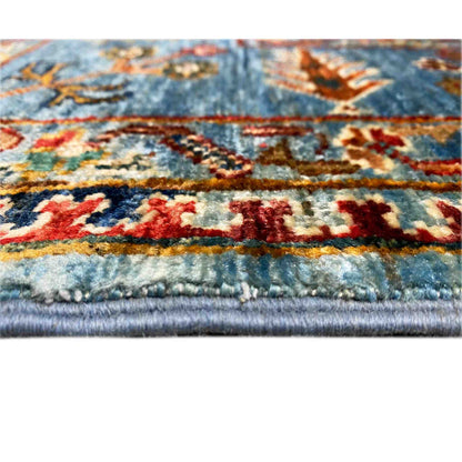 Close-up: blue Khorjin rug with colorful ornaments and fringes