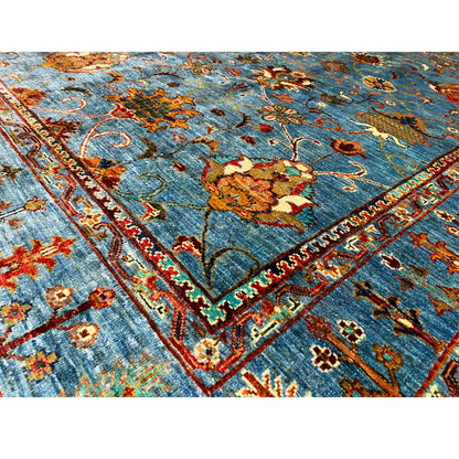 Close-up: blue Khorjin rug with red, yellow, and green ornaments