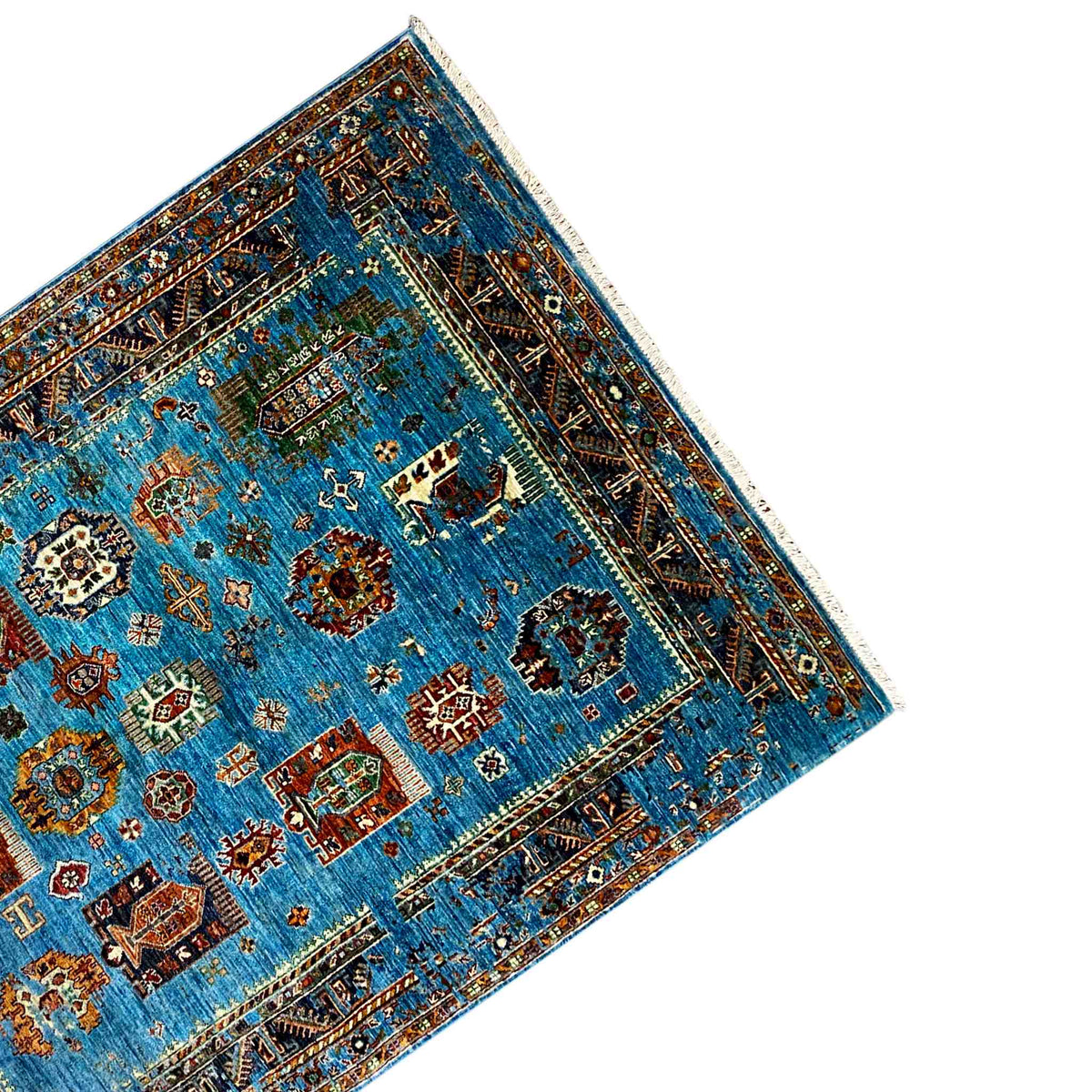 Corner view: blue carpet with an all-around border, rounded pattern area, and fringes