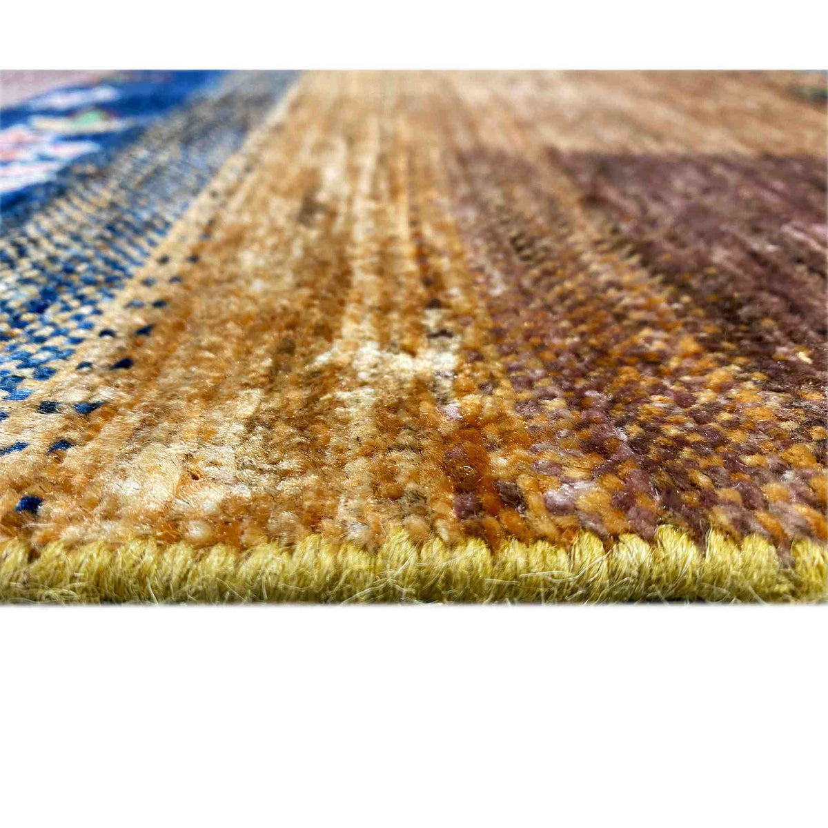 Carpet pile in detail, multicolored patterns and fringed edging along the border