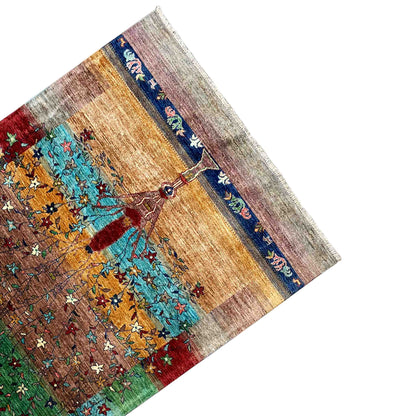 Corner of the multicolored Afghan Khorjin rug with a blue-red border and tree motif