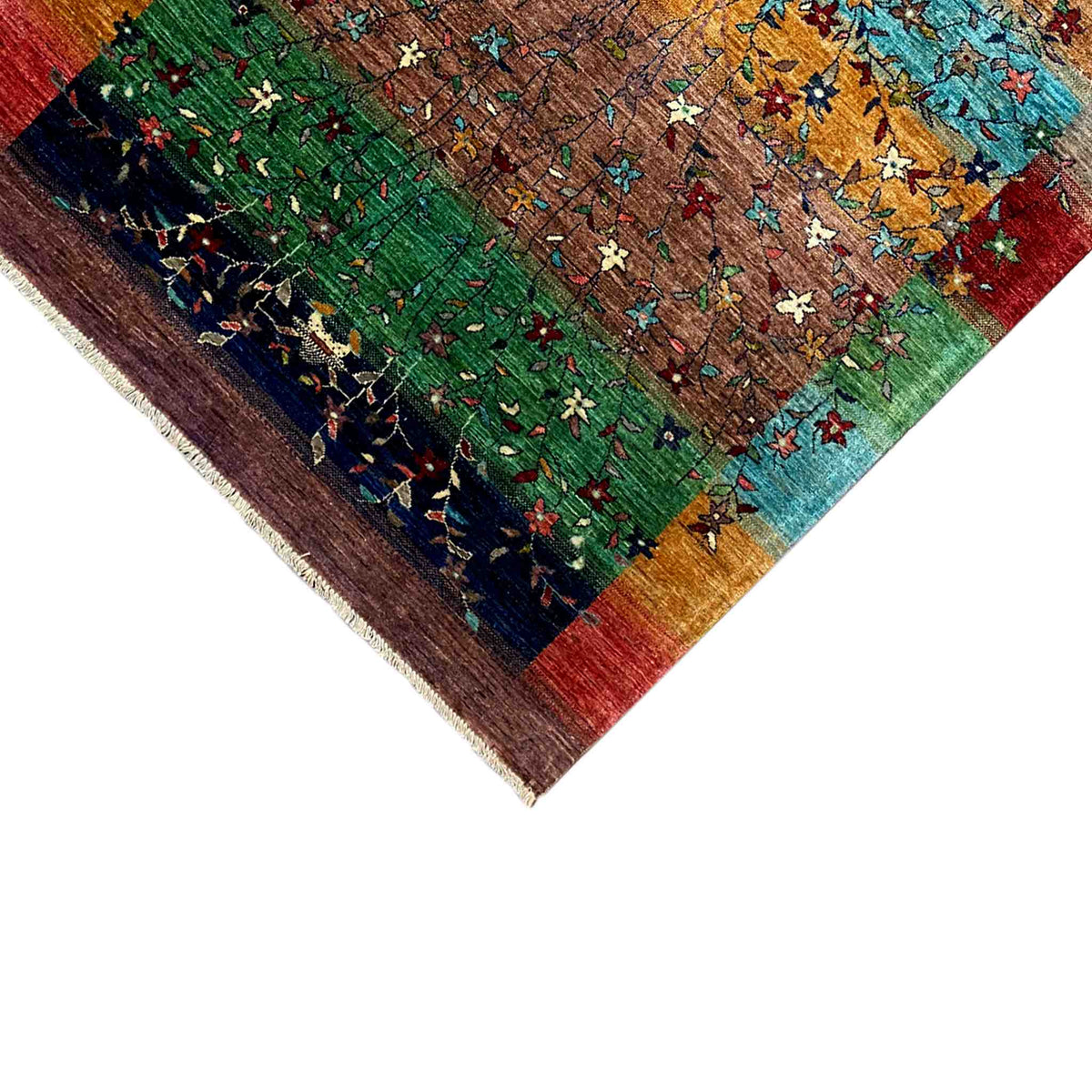 Close-up of the carpet corner with green fields, star motifs, and a fringed edge