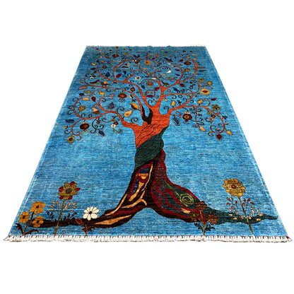 Blue Afghan Khorjin rug with a central tree, a figure at the bottom, and a fringed border