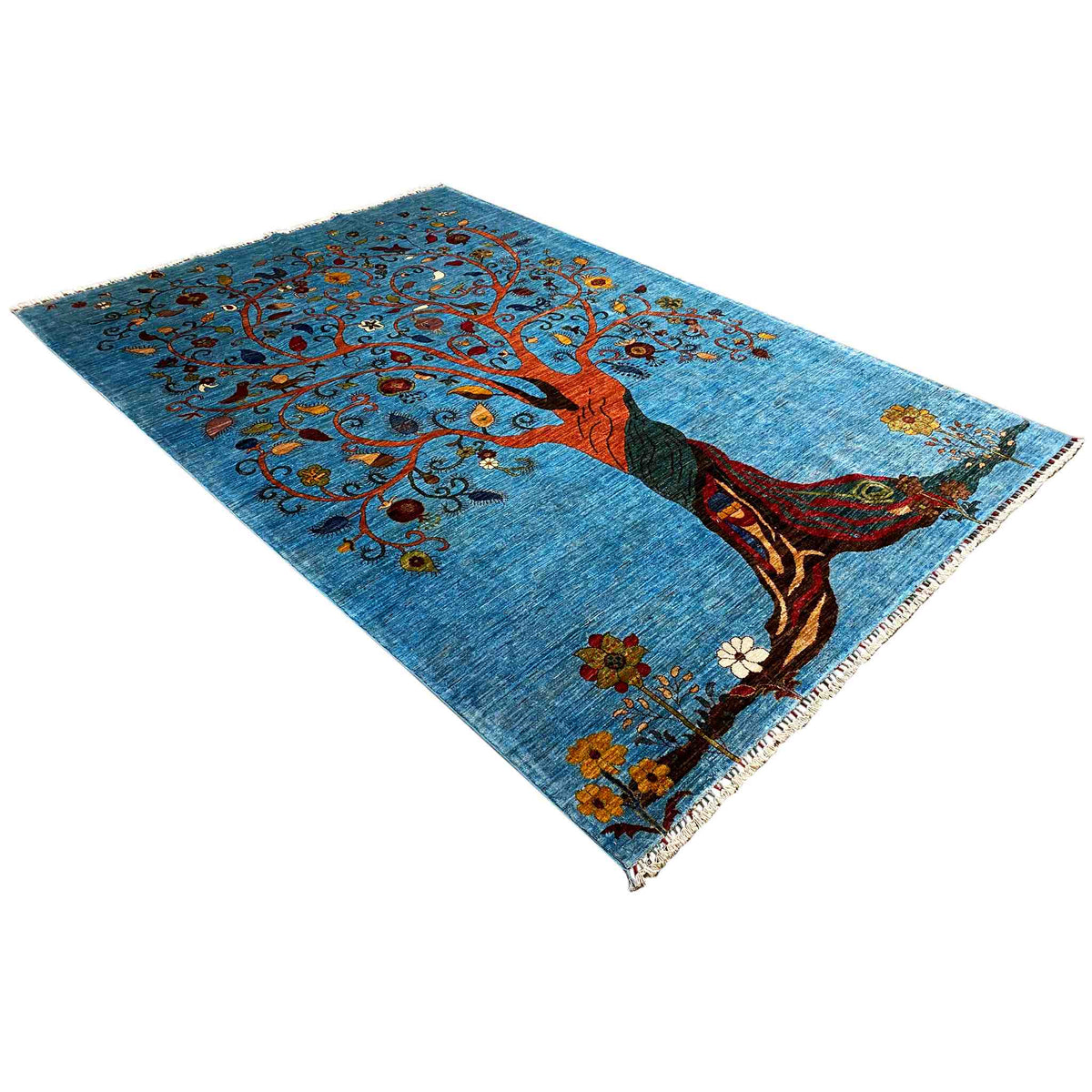 Blue rug with tree motif and seated figure, decorative vines and fringes