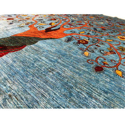 Detail: Blue carpet fabric with a tree motif and colorful ornaments
