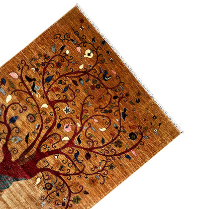 Corner view: Afghan Khorjin rug with tree motifs, fringe, and a finished edge
