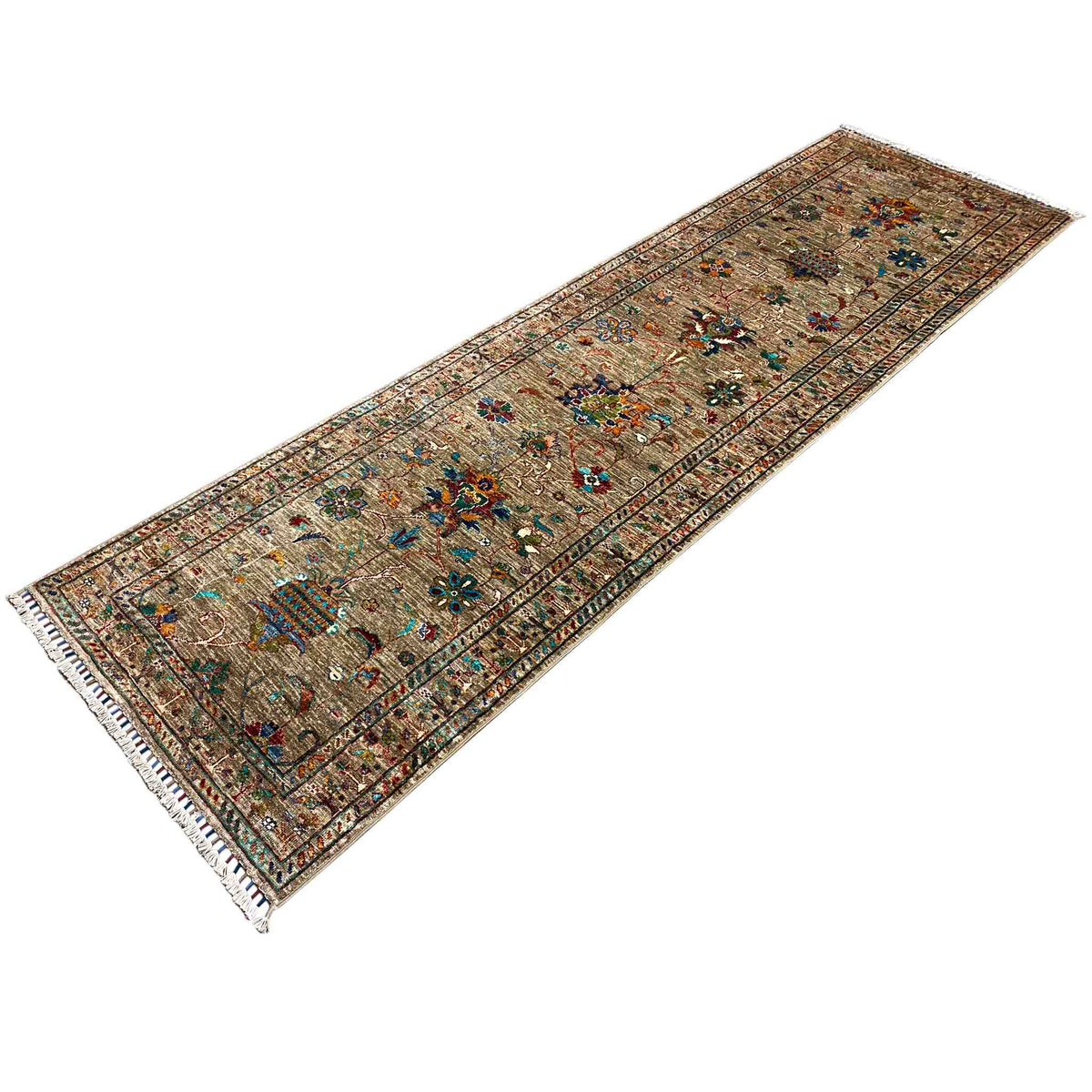 Brown runner rug with contrasting decorative borders and fringed edges