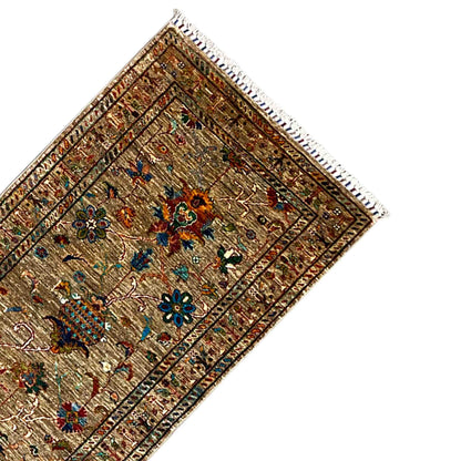 Corner runner rug with a brown background, fine lines, and colorful flowers, fringes visible