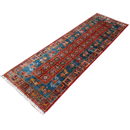 Blue-and-red patterned runner rug with animal motifs and fringes along the edges