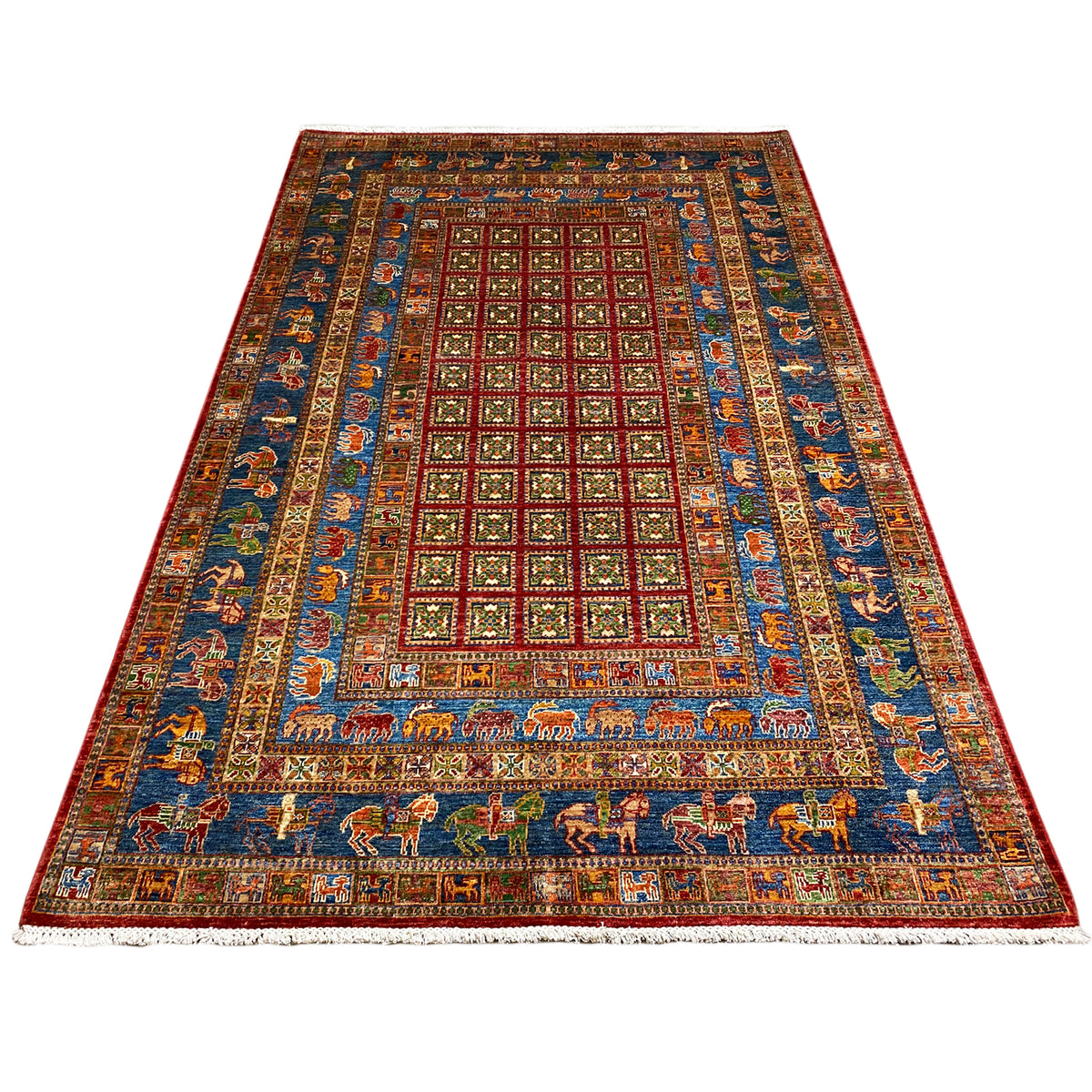 Hand-knotted Khorjin rug, shown at an angle: medallion pattern in blue, red, green