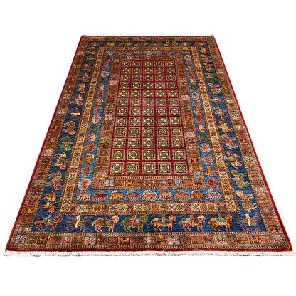 Hand-knotted Khorjin rug, shown at an angle: medallion pattern in blue, red, green