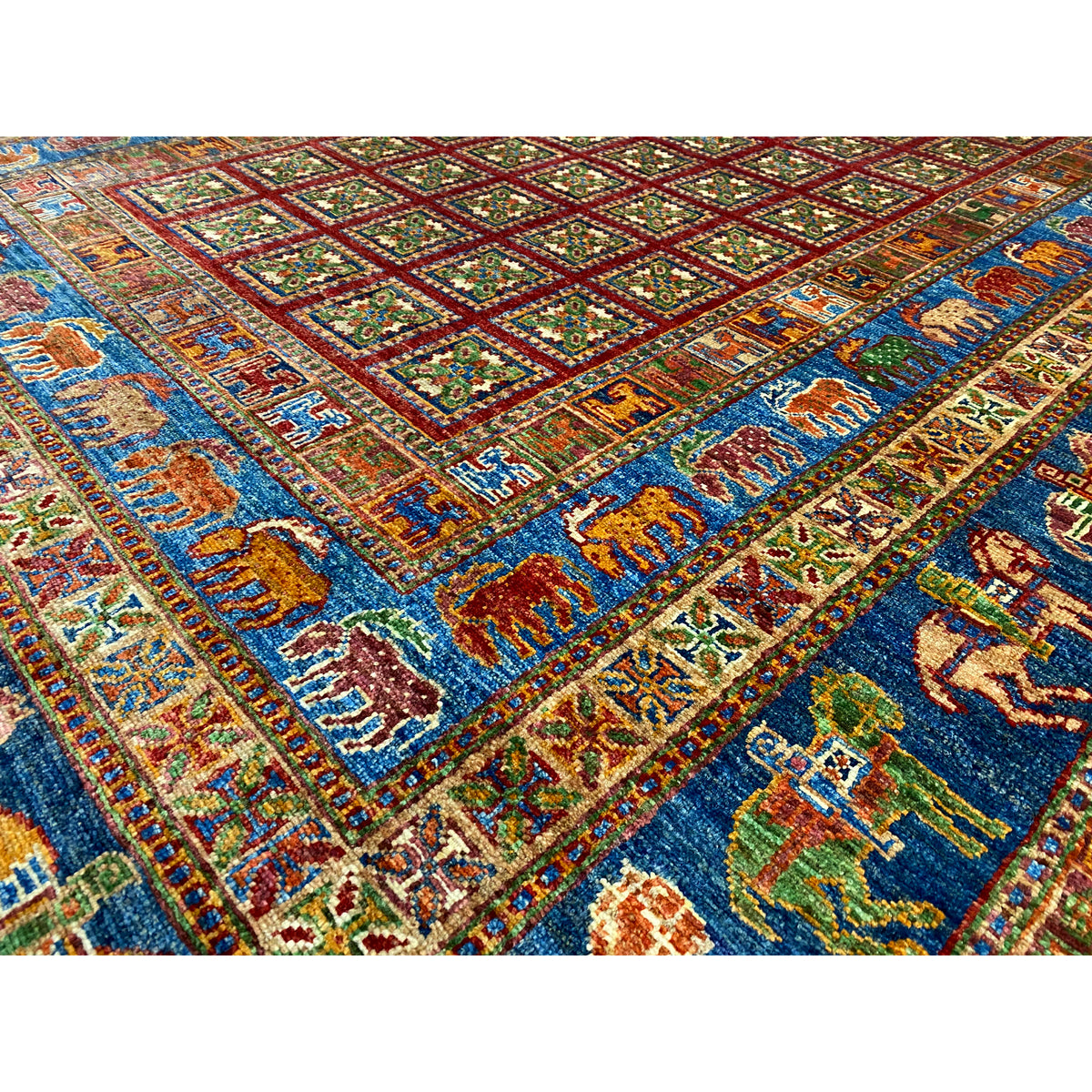 Hand-knotted Khorjin rug: close-up with a blue field, red patterns, and ornaments