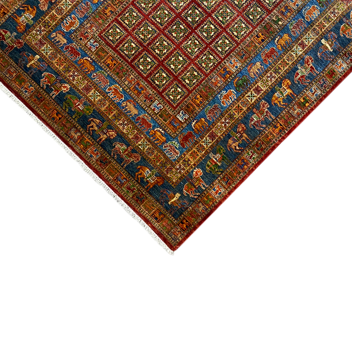 Hand-knotted Khorjin rug: detail of the corner with border, white trim, and fringes