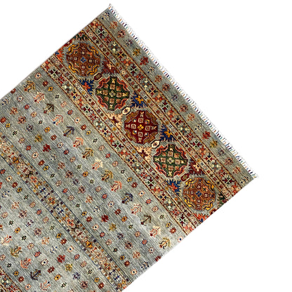 Hand-knotted Khorjin rug with a decorative border and fringe, light gray with colorful accents