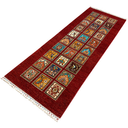 Hand-knotted Khorjin runner with a red background and colorful square mosaic, fringed edge