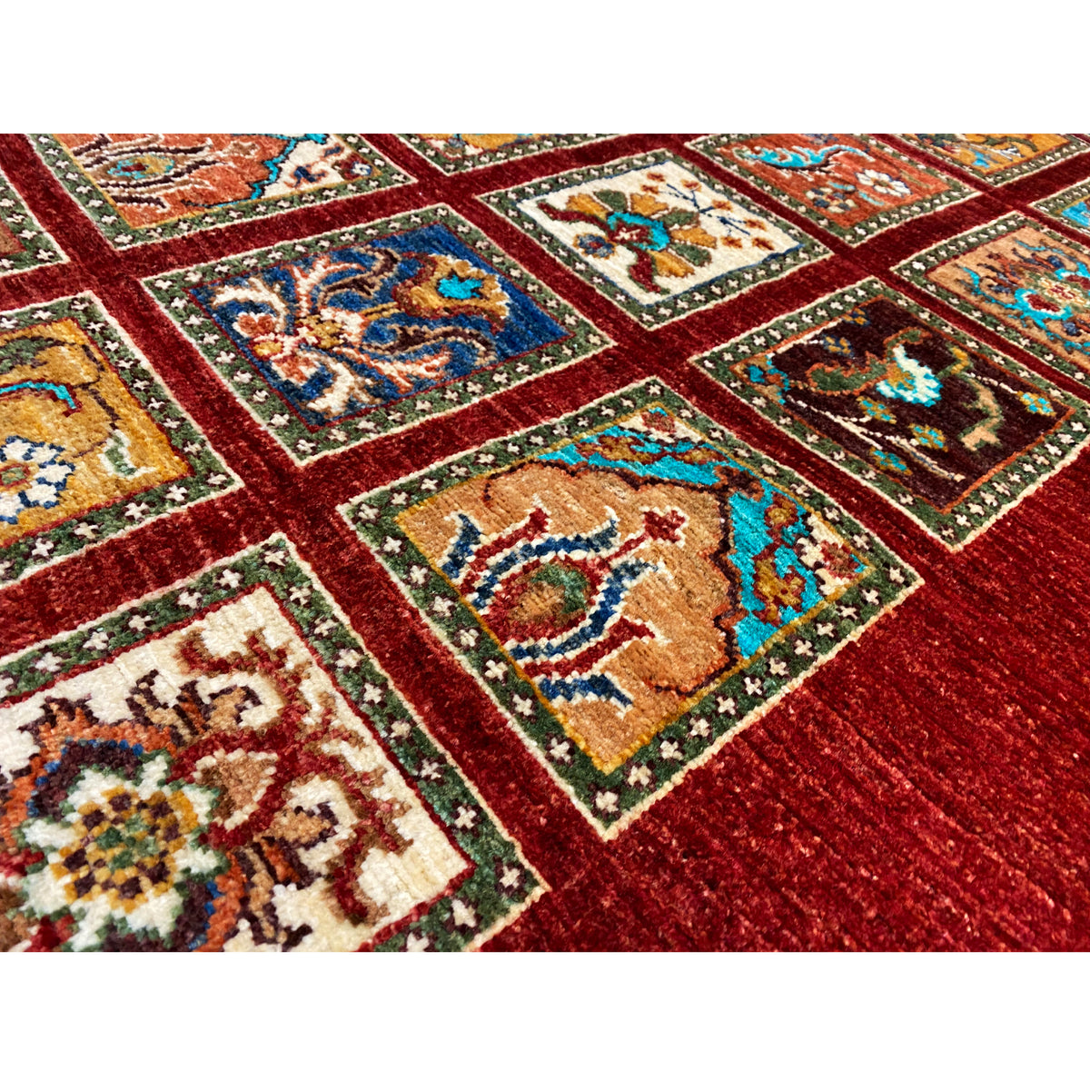 Close-up view: red runner with colorful ornamental squares and a fine patterned border