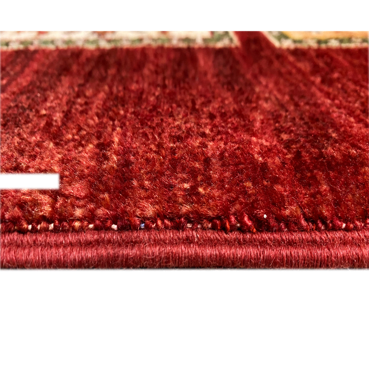 Close-up of the red pile and a light overlocked border along the runner’s edge