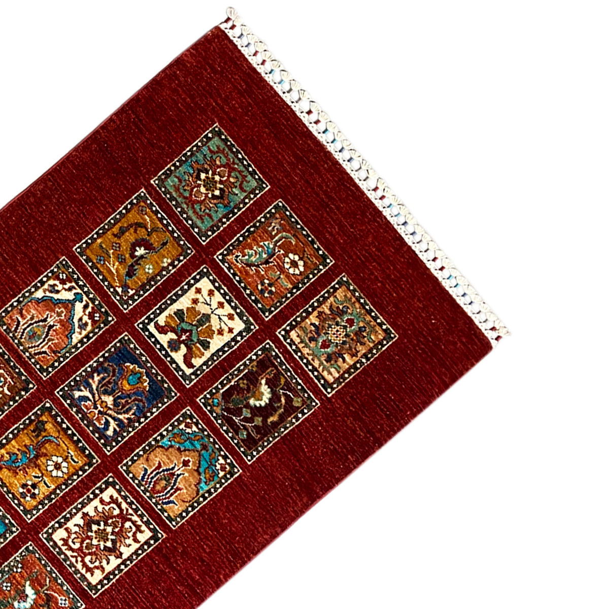 Corner of the hand-knotted Khorjin runner: red square pattern with white overcast edging