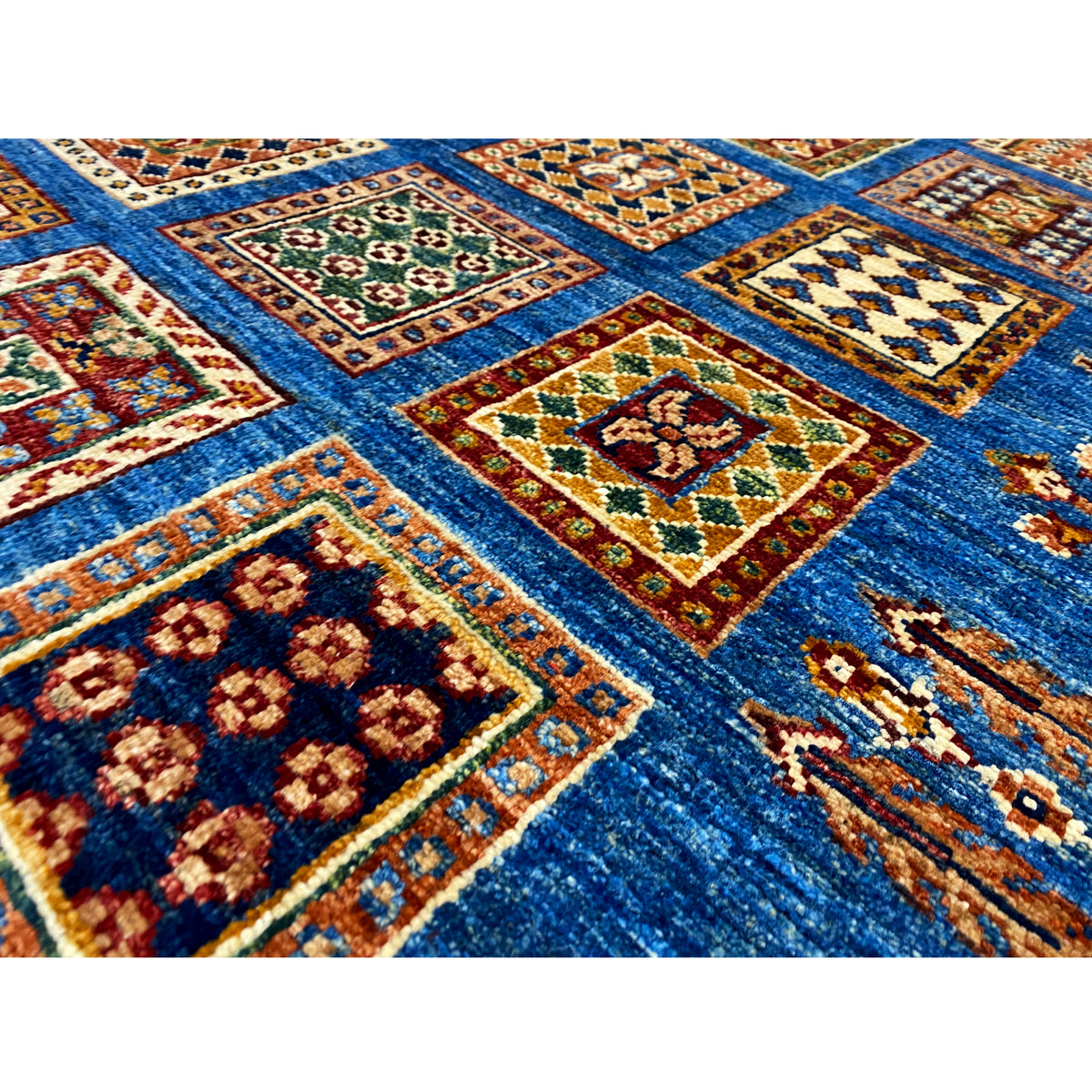 Khorjin runner detail: colorful squares on a blue background, pile and pattern visible