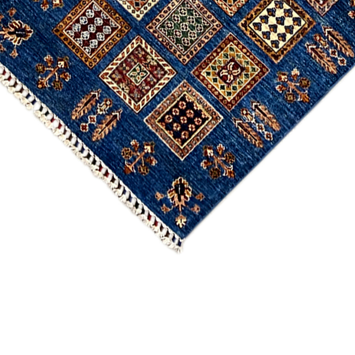 Khorjin runner corner with fringed trim and geometric patterns on a blue background