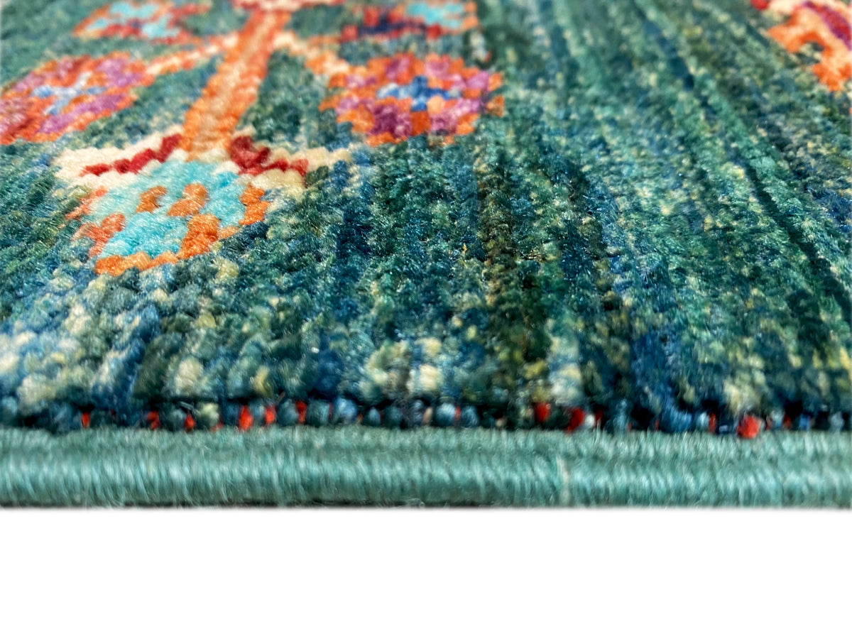 Detail of the Khorjin runner: pile structure on a dark green border with fringed edging