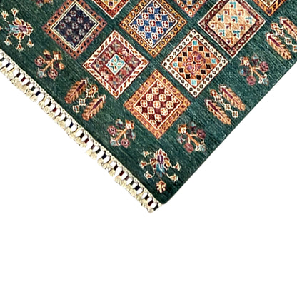 Khorjin runner detail at the hem: dark green with a square border and rows of fringe