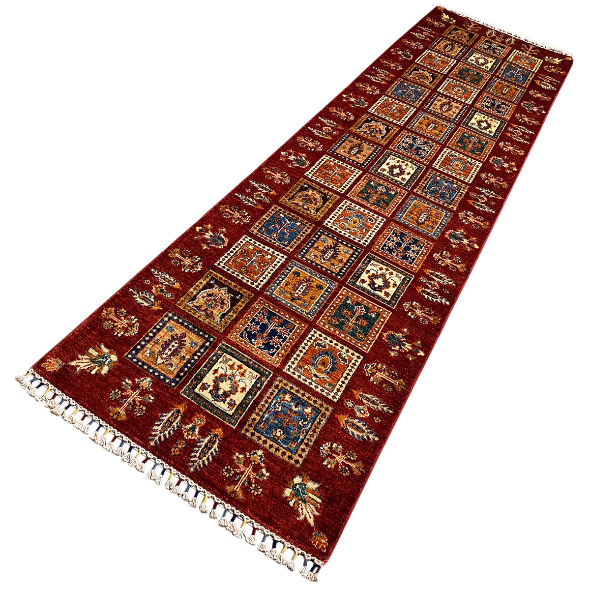 Khorjin runner with colorful squares, oriental patterns, and shaggy fringe.