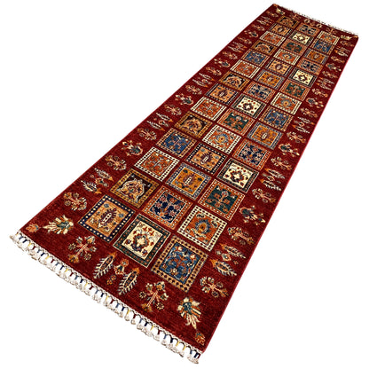 Khorjin runner with colorful squares, oriental patterns, and shaggy fringe.