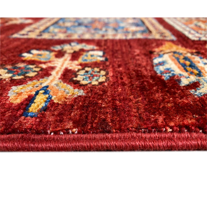 Fabric detail at the edge: red pile with multicolored squares, finished edge.