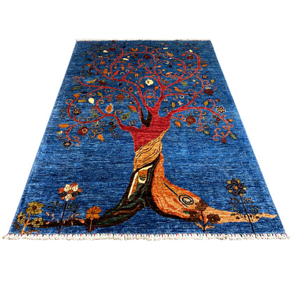 Hand-knotted rug with a tree of life motif, a blue field design, and brightly embroidered details