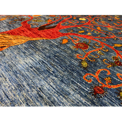 Detailed view: blue carpet with a red trunk and multicolored orange vines, decorative ornaments