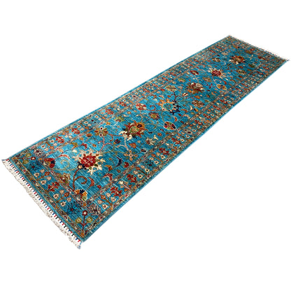 Hand-knotted blue runner with a multicolored ornamental pattern, fringed edges