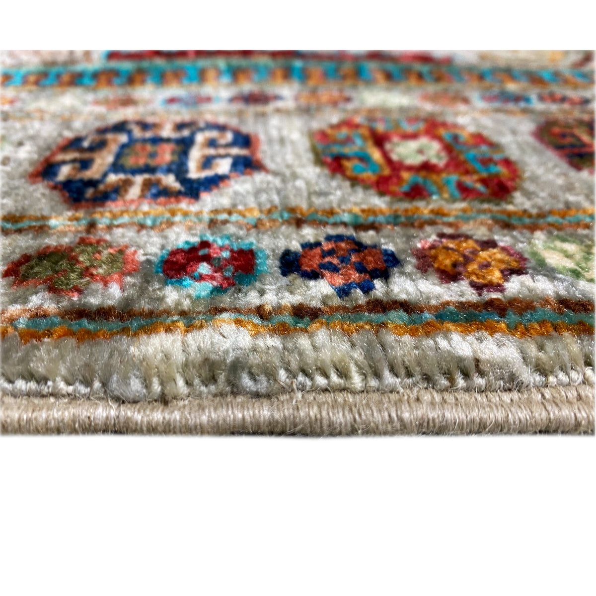 Khorjin runner close-up: fringed edge with tassels and multicolored motifs
