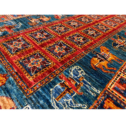Detail of the hand-knotted Khorjin runner: blue field with red borders and motifs.